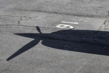 Shadow of a Small Airplane Tail on the Asphalt of the Palo Alto Airport in California, USA