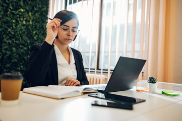 Business working on a laptop in a creative office environment