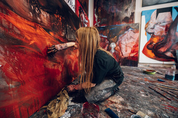 Female painter artist painting and creating her art in a creative studio