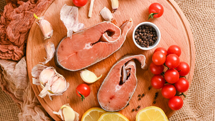  Raw red fish steaks on a wooden cutting board, ingredients for cooking. High quality photo