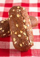 Dark Brown Bread with Oats on a Red and White Table Cloth