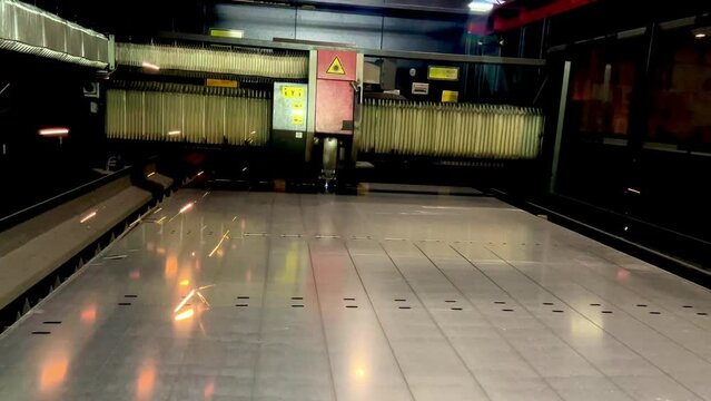 video 4k of Laser cutting. Metal machining with sparks on CNC laser engraving maching