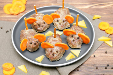 Small meatball mouse, meatloaf mice with ears of carrot, cheese on plate, creative and fun food snack idea for kids party. Menu for spooky Halloween dessert treats, edible cute rat selective focus