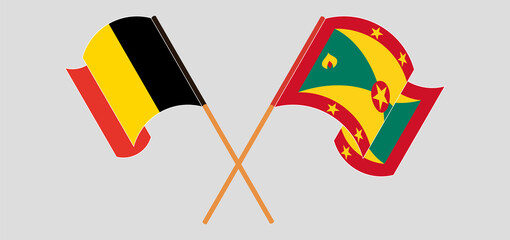 Crossed and waving flags of Belgium and Grenada