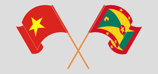 Crossed and waving flags of Vietnam and Grenada