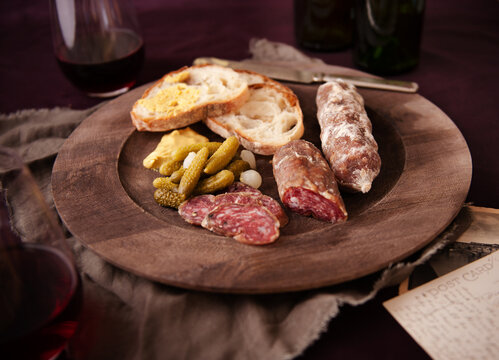 Salami with bread, mustard and gherkins 