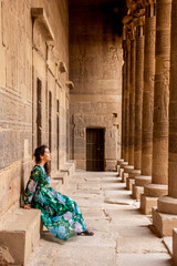 Fototapeta premium Woman between Pillars of Philae Temple, Aswan, Egypt