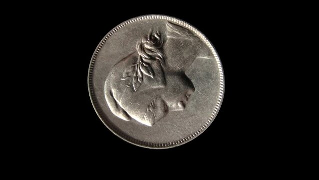 Rotating reverse of Portugal coin 4 centavos, 1917 with image of a girl. Isolated in black background. 