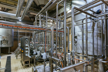 Industrial steel vats connected by the pipeline