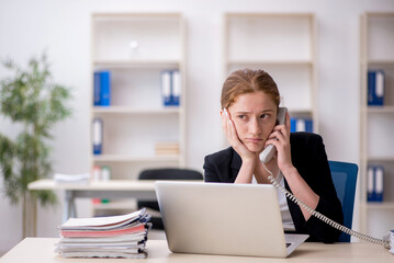 Young female employee working in the office