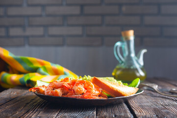 helthy breakfast. fried shrimps with avocado and toasts