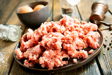 Raw mince lamb, ground mutton meat with herbs on a plate.