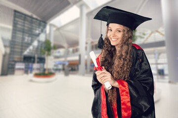 Young woman graduate student with diploma