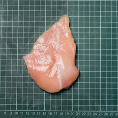 Raw chicken fillet meat without skin without bone, for cooking.Fresh chicken fillet on line board.
