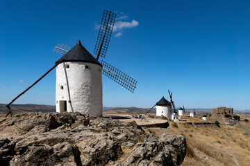 Traditional white windmills on the top of the hill in Consuegra, Spain, in a sunny day.