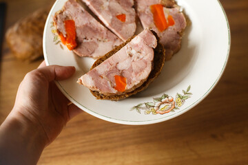 Homemade ham on a beautiful vintage plate. Cooking meat dishes at home. Beautiful food presentation. The concept of healthy proper nutrition.