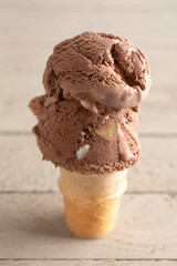 Chocolate Rocky Road Ice Cream Cone on a Wood Table