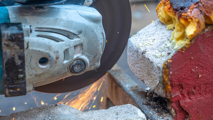 Close-up view of a worker working with angle grinder. Electric wheel grinding on steel structure. Sparks.