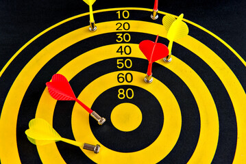 Darts game, yellow and black dartboard with sticky darts