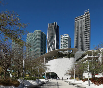 Phillip and Patricia Frost Museum of Science curved white entrance with tall skyscrapers in the background in downtown Miami, Florida, USA. 