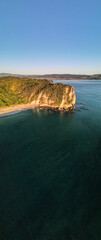 Sunrise over Cooks Beach coastline along the Coromandel Peninsula in New Zealand's North Island.