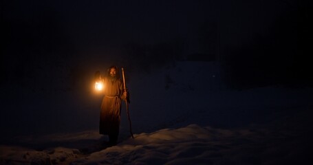 Hermit with lantern walking at night