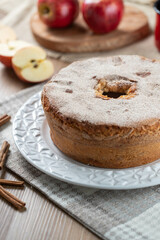 Sponge cake or chiffon cake with apples so soft and delicious sliced ​​with ingredients: cinnamon, eggs, flour, apples on wooden table. Home bakery concept for background and wallpaper