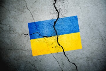 An image of the flag of Ukraine on a wall with a crack. A crisis.