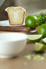 Close up piece of Moist lemon fruit cake on plate with lemon slices on wooden table. Delicious breakfast, traditional tea time. Lemon cake recipe.