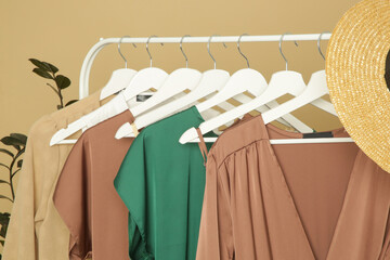 Display of elegant silk clothes on rack. Luxurious garments in fashion atelier.