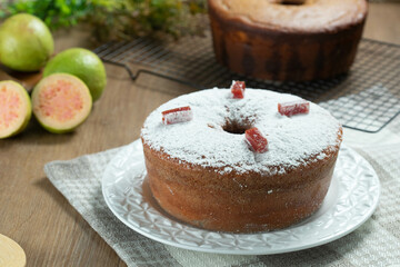Brazilian corn cake made with a type of corn flour (Fuba) filled with guava paste. On a wooden party table. Typical sweets of the June festival. Cornmeal cake