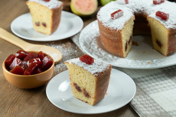 Brazilian corn cake made with a type of corn flour (Fuba) filled with guava paste. On a wooden party table. Typical sweets of the June festival. Cornmeal cake