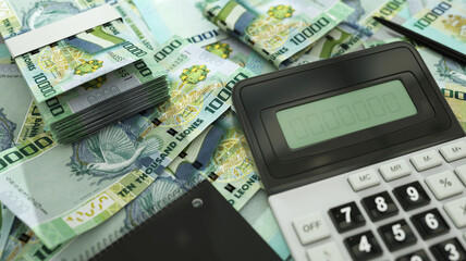 Sierra Leonean leone notes spread out  with a calculator, pen and notebook. 3d rendering