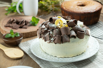 White chocolate and dark chocolate cake two loves on wooden table. Birthday and wedding cake
