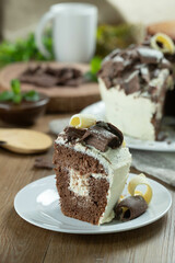Close up piece of White chocolate and dark chocolate cake two loves on wooden table. Birthday and wedding cake