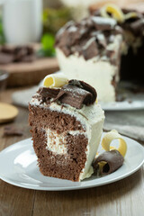 Close up piece of White chocolate and dark chocolate cake two loves on wooden table. Birthday and wedding cake