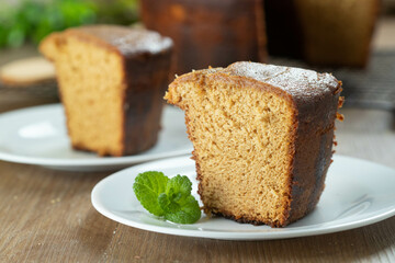 Close up piece of Brazilian corn cake made with a type of corn flour (Fuba). On a wooden party table. Typical sweets of the June festival. Cornmeal cake