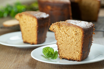 Close up piece of Brazilian corn cake made with a type of corn flour (Fuba). On a wooden party table. Typical sweets of the June festival. Cornmeal cake