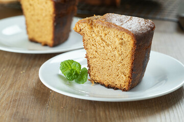 Close up piece of Brazilian corn cake made with a type of corn flour (Fuba). On a wooden party table. Typical sweets of the June festival. Cornmeal cake