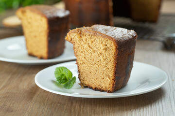 Close up piece of Brazilian corn cake made with a type of corn flour (Fuba). On a wooden party table. Typical sweets of the June festival. Cornmeal cake
