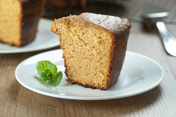 Close up piece of Brazilian corn cake made with a type of corn flour (Fuba). On a wooden party table. Typical sweets of the June festival. Cornmeal cake
