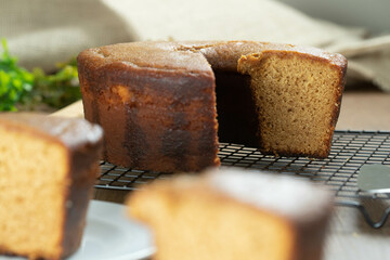 Close up piece of Brazilian corn cake made with a type of corn flour (Fuba). On a wooden party table. Typical sweets of the June festival. Cornmeal cake