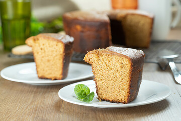 Close up piece of Brazilian corn cake made with a type of corn flour (Fuba). On a wooden party table. Typical sweets of the June festival. Cornmeal cake