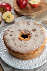 Sponge cake or chiffon cake with apples so soft and delicious sliced ​​with ingredients: cinnamon, eggs, flour, apples on wooden table. Home bakery concept for background and wallpaper
