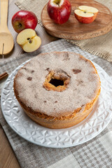Sponge cake or chiffon cake with apples so soft and delicious sliced ​​with ingredients: cinnamon, eggs, flour, apples on wooden table. Home bakery concept for background and wallpaper