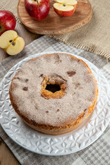 Sponge cake or chiffon cake with apples so soft and delicious sliced ​​with ingredients: cinnamon, eggs, flour, apples on wooden table. Home bakery concept for background and wallpaper. Top view.