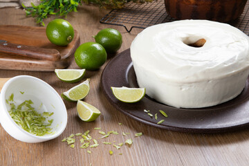Moist lemon fruit cake on plate with lemon slices on wooden table. Delicious breakfast, traditional tea time. Lemon cake recipe.