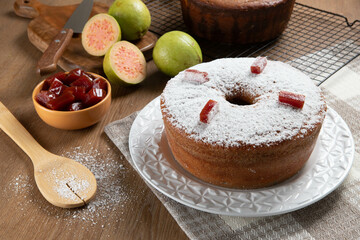 Brazilian corn cake made with a type of corn flour (Fuba) filled with guava paste. On a wooden party table. Typical sweets of the June festival. Cornmeal cake