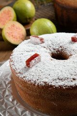 Brazilian corn cake made with a type of corn flour (Fuba) filled with guava paste. On a wooden party table. Typical sweets of the June festival. Cornmeal cake