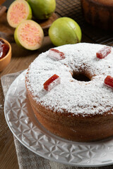 Brazilian corn cake made with a type of corn flour (Fuba) filled with guava paste. On a wooden party table. Typical sweets of the June festival. Cornmeal cake